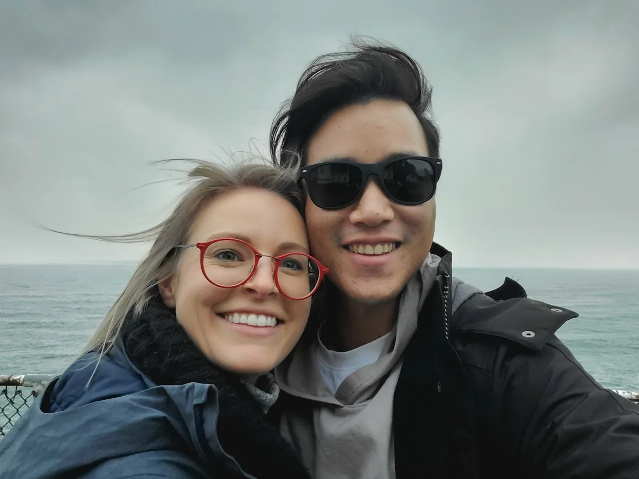 Carolyn and Daniel on a beach at sunset